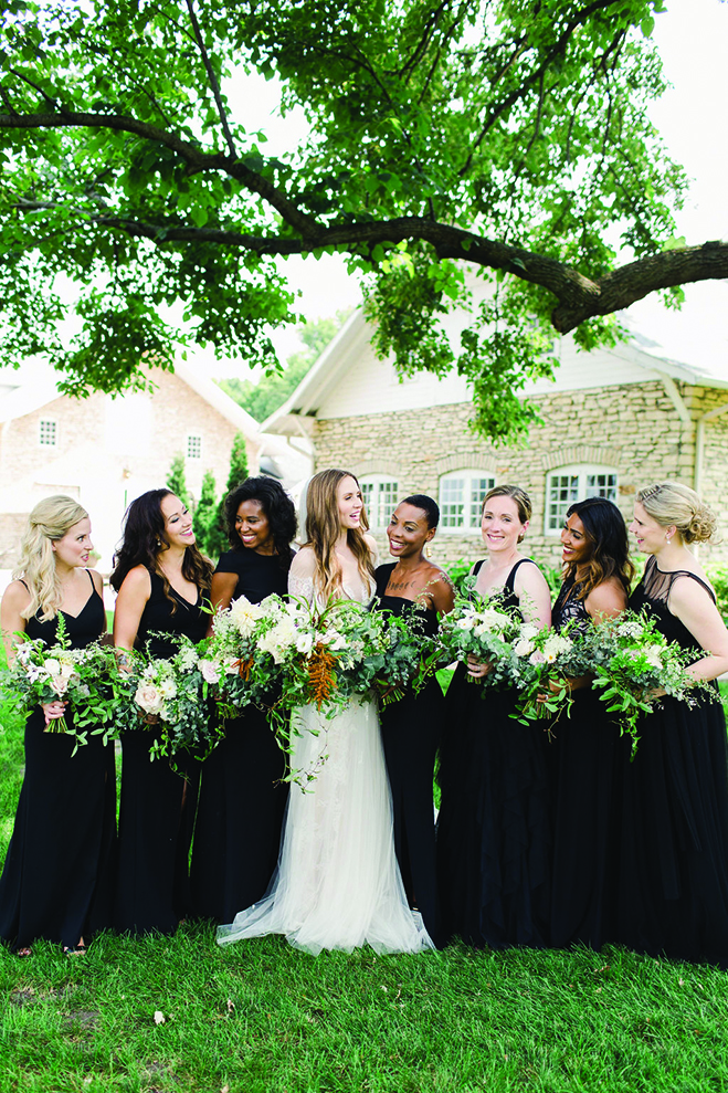 Laura poses with her bridesmaids at Mayowood Stone Barn