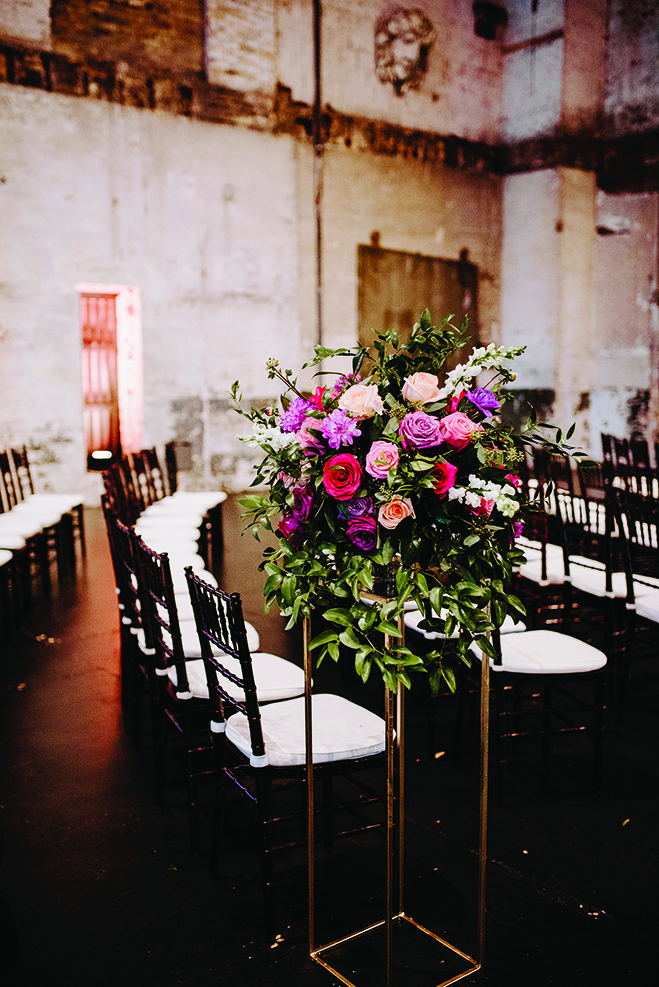 Flowers sit in front of a table at Molly and Seth's wedding at Aria