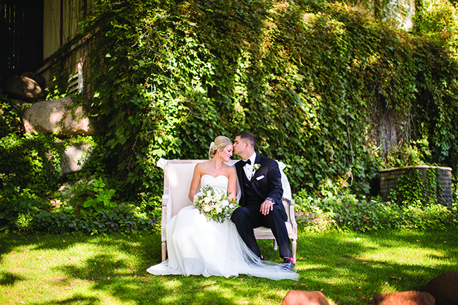 Jake kisses Paige's forehead as the two sit on a bench at the Wayzata Country Club