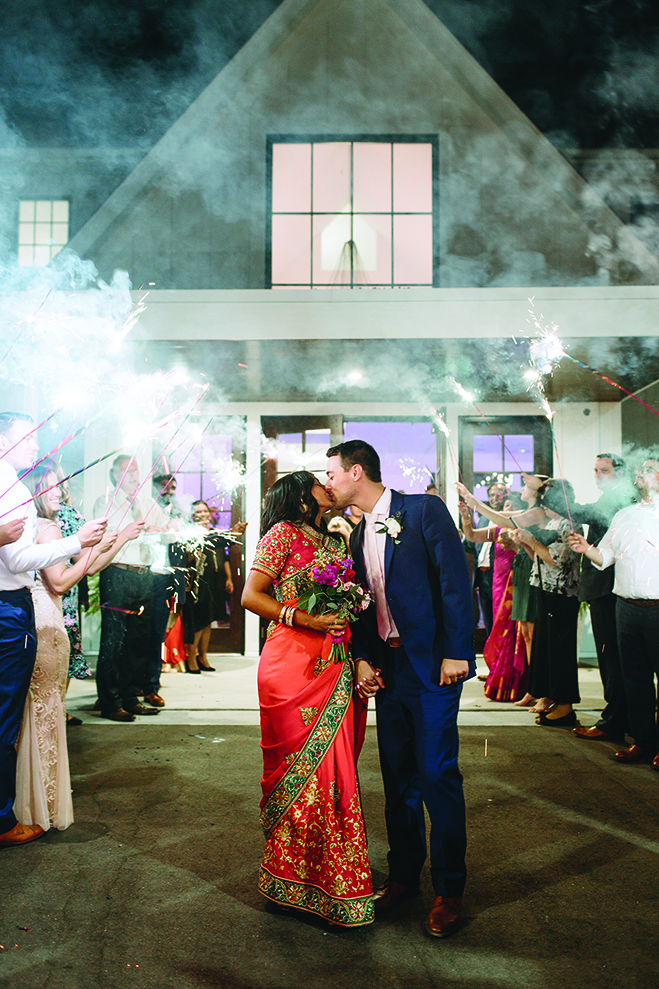 Ruwani and Zach kiss in front of the Hutton House after their reception.