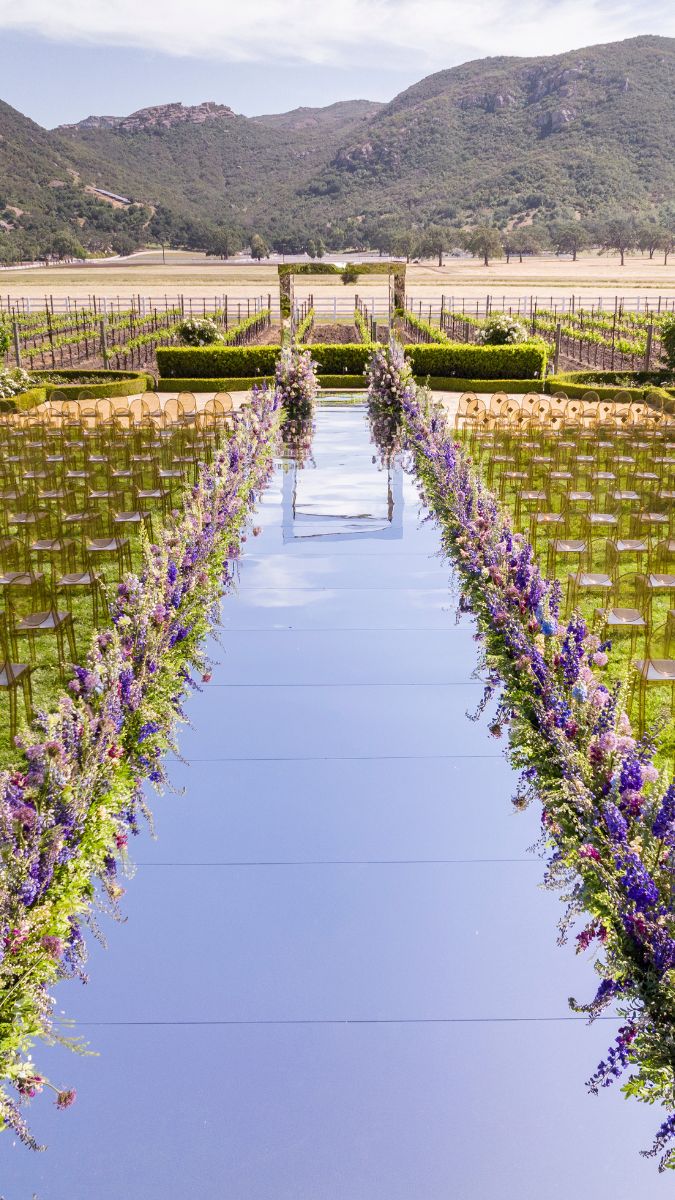 Mirrored aisle at creative garden ceremony