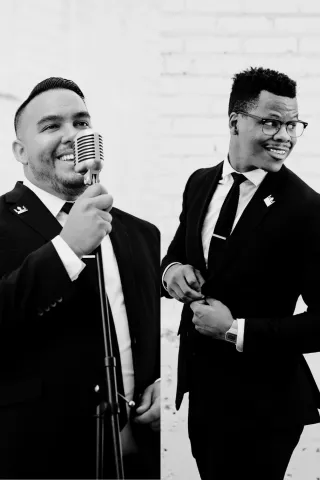 Black-and-white portraits of Cornell Leffler & Ether Saure from the Downtown Collective band, one singing into a vintage microphone and the other adjusting his suit jacket.