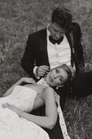 Bride rests her head on the groom's lap on their wedding day at Woods & Co.