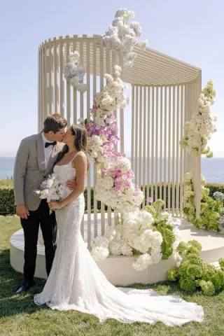 Ella and Caden share a kiss by their custom made modern altar 