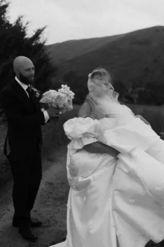 Jenni and Coby get caught in the rain during portraits at Dismal River Club