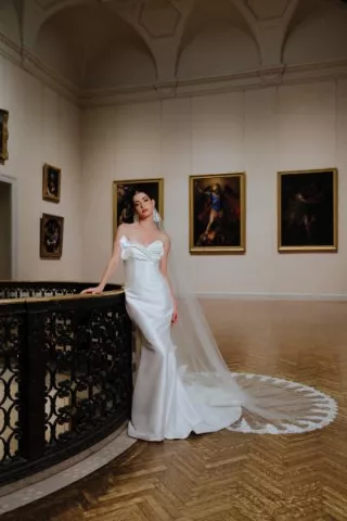 Model poses in bridal gown amidst artwork at Minneapolis Institute of Art