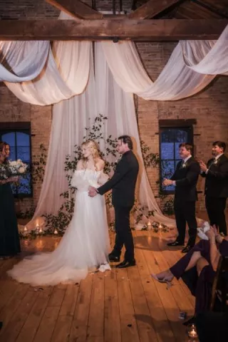 Elizabeth and Matthew standing at the altar on their wedding day at The Lageret