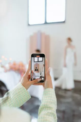 Content creator taking candid video of a bride