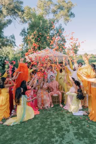 Bride and groom are showered in rose petals in celebratory opening evening for wedding weekend at Grand Hyatt Scottsdale REsort