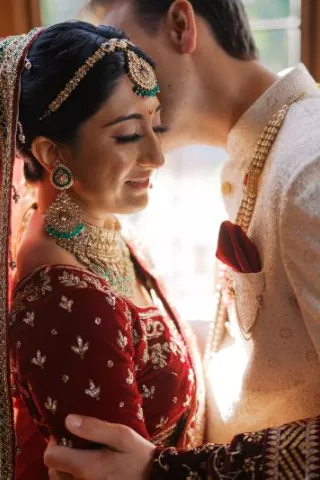Bride and groom embrace in their traditional Indian garb in wedding day at Lairmont Manor