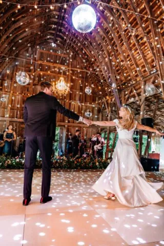 Bride and groom dance together covered in disco lights in reception at Arbor Day Farm 
