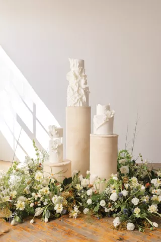 Chic and Elegant Wedding Cakes Displayed Amongst Fresh Florals