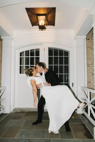 Jack dips Abby into a kiss in their lakeside wedding day at a private residence