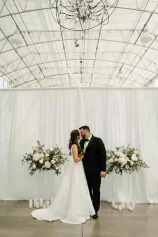 Lauren and Nathan share a kiss at the altar on their wedding day at Greenhouse No 7