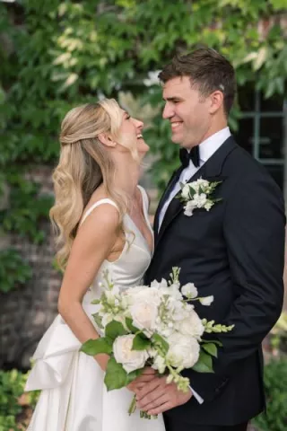 Anna and Grant share a laugh at their lakeside wedding day