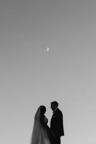 Tsion and Ben stand looking at each other under the moon. 