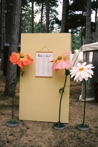 Handmade paper florals around seating chart 
