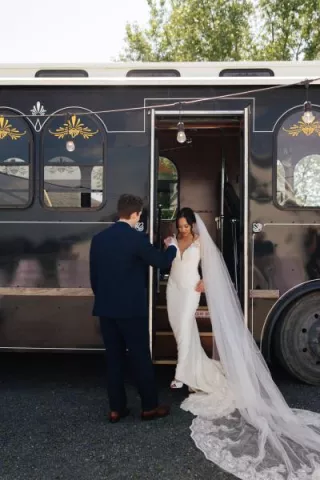 Chonhanh and Nicholas pose on the steps of their wedding day trolley