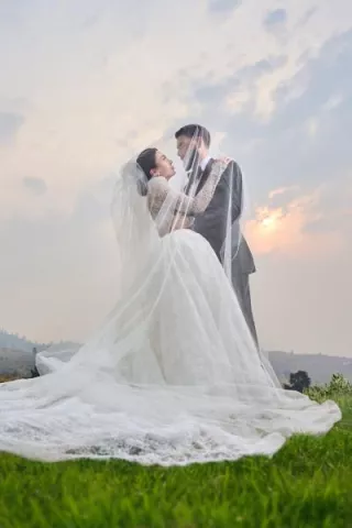 Noelle and Richard embrace as the sun sets behind them on their wedding day at Larc Hill Vineyard
