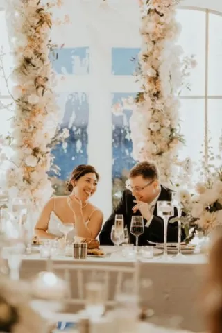 Lauren and William Share a Smile Surrounded by Whimsical Florals