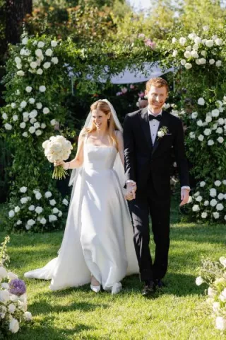 Bride and groom walk back down aisle at the end of enchanted garden wedding ceremony at The Lodge at Malibou Lake