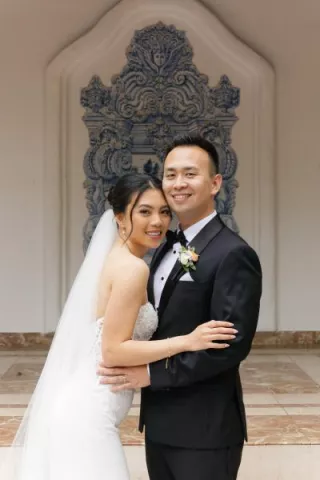 Thao and Corey smile and pose on their wedding day at Rancho Las Lomas