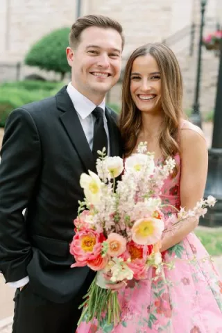 Bride and groom pose together on their winning wedding day