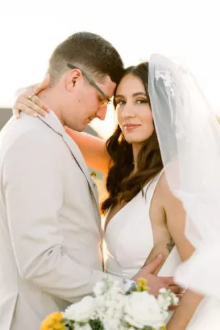 Close up of the bride and groom in an embrace with their foreheads pressed together on the grounds of Bella Terre Vineyard