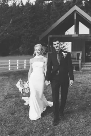 Ashley and Jaxson walk hand in hand on the grounds of Wind Mountain Ranch