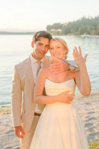 Courntey and Alden pose by the lake on their wedding day