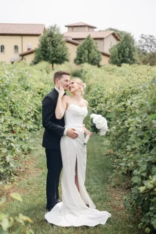 Layne and Nick pose in their wedding attire on the grounds of  Villa Bellezza