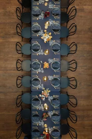 Bold tablescape featuring dark navy tones and metallic accents in one long table at Ellsworth Block