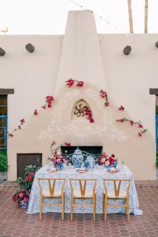 Bold and romantic reception table framed by the storied Hacienda del Sol