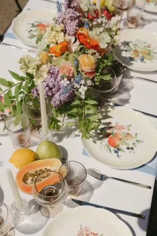 Minimal beach tablescape with bright florals and fruit accents at Pelican Brewing