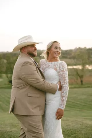 Monica and Matt pose in their wedding attire at their private residence 