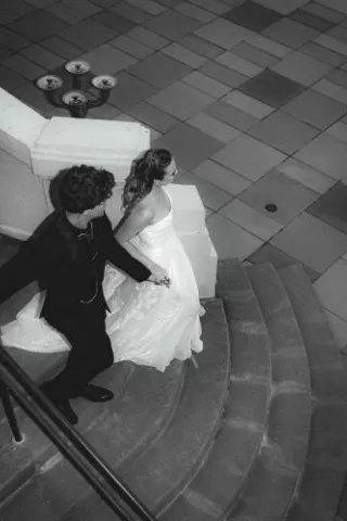 Bride and groom descend staircase at Maryhill Museum of Art