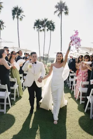 Jordin and Allan cheer as they walk back down the aisle 