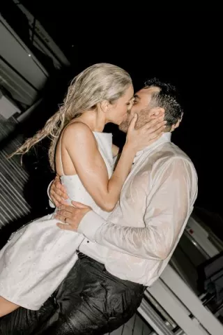 Bride and groom share a kiss after jumping in Lake Geneva in their wedding attire