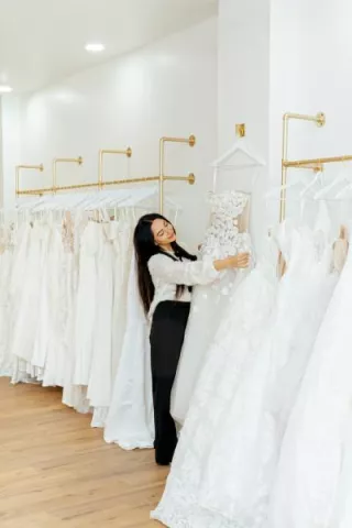 Owner of Mareh Couture Bridal with the dresses on display