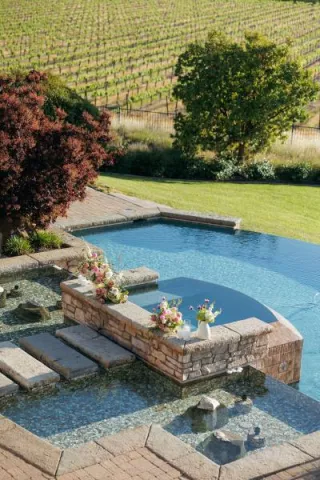 Pink florals in vases decorate the poolside reception at Mira Vista Estate