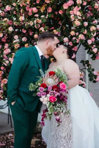 Molly and Kevin Share a Kiss in Modern and Vibrant Wedding with Unique Florals at Holbrooke Hotel