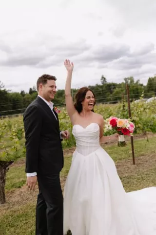 Amanda and Sam cheer on their wedding day at Oswego Hills Winery