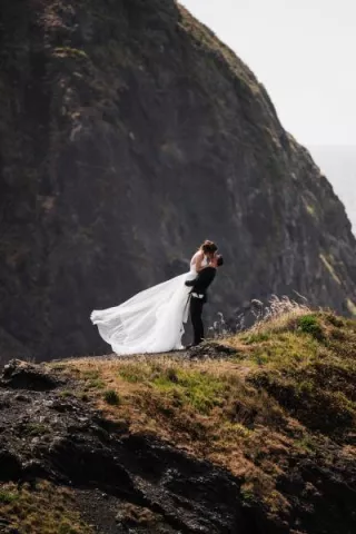 Olivia and Bryan kiss on the coast of Oregon 