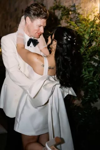 Bride and groom embrace in their after-party attire in wedding day at Monserate Winery