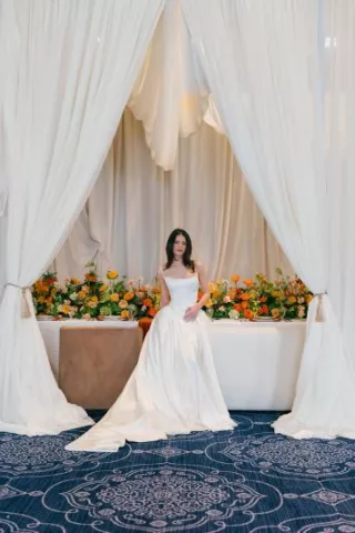 Model poses in front of boldly styled reception table at The Sentinel