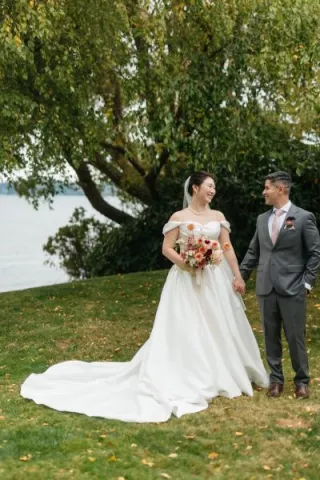 Jane and Abner pose in their wedding attire on the grounds of The Woodmark Hotel & Still Spa