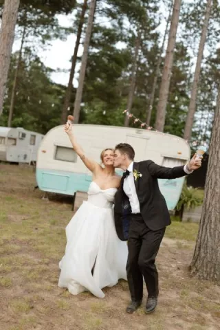 Molly and Ralph pose with their ice cream cones on their wedding day at Camp Elsewhere