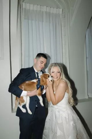 Keland + Dillon posing with their beloved king charles dog