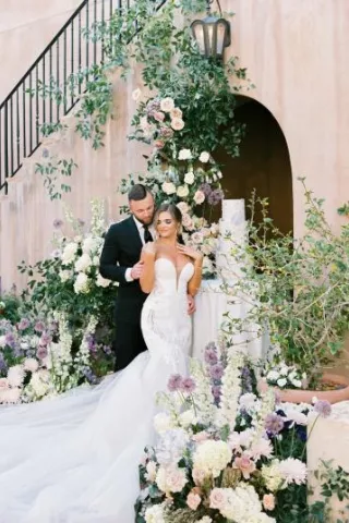 Couple Posing in Opulent and Airy Styled Shoot at Silverleaf Country Club featuring Elegant Pastel Florals