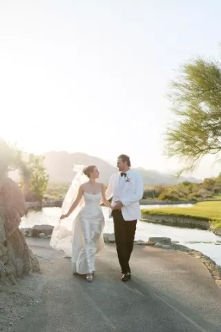 Emily and Vladimir cross the grounds of The Reserve Club during golden hour on their wedding day